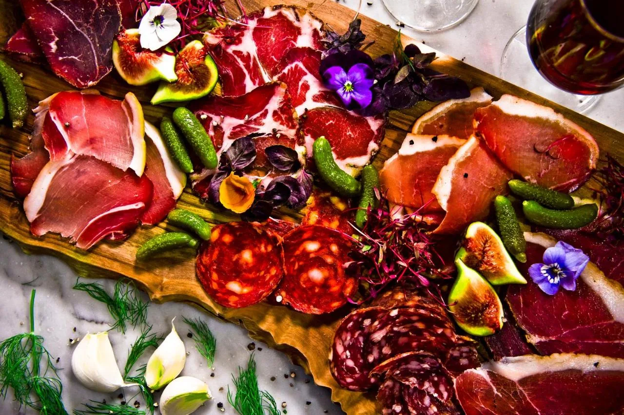 a plate of food with vegetables on a table at Club Quarters Hotel Trafalgar Square, London in London